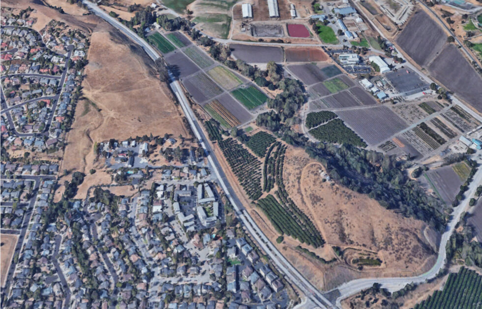 Aerial view of Cal Poly agricultural fields and nearby residential neighborhoods in San Luis Obispo.