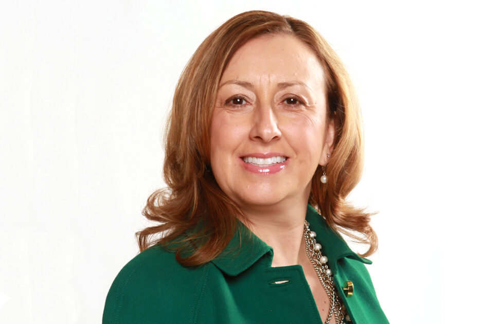 Cindy Villa in a green blazer smiling against a bright white background