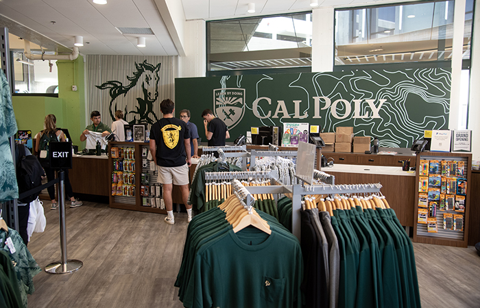 Interior view of the Cal Poly Mustang Shop with students shopping for apparel and supplies