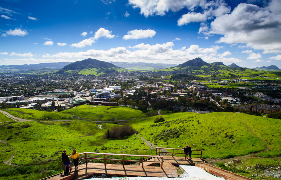 Panoramic view of San Luis Obispo and Cal Poly campus from a green hillside trail