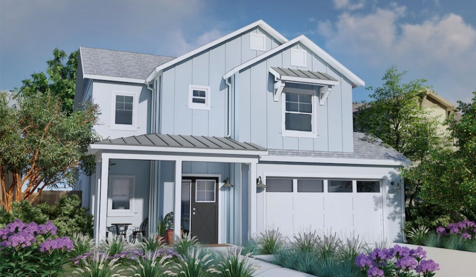 Modern two-story light blue home at Vista Meadows with a front porch, two-car garage, and landscaped yard.