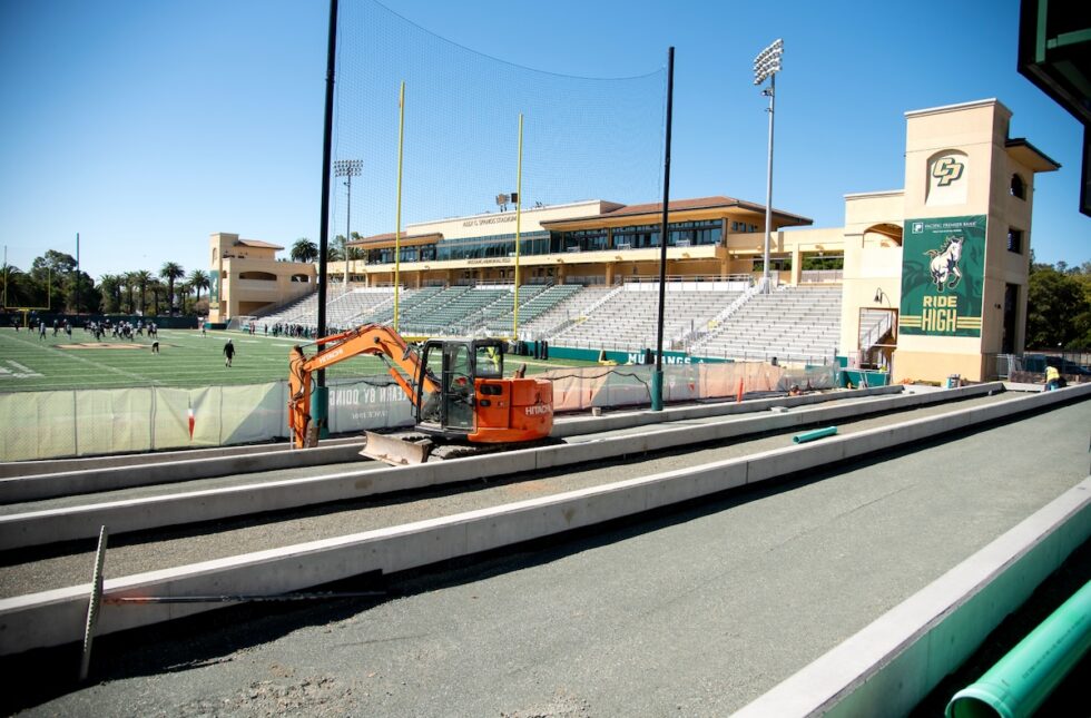 View of Cal Poly’s football stadium with “Ride High” banner and ongoing field construction.